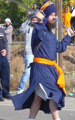 BHAI HARGOBIND SINGH SPINING TWO SWORDS.